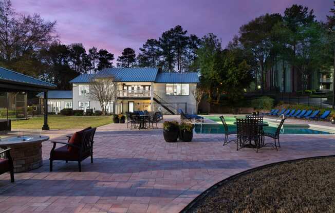 a backyard with a paver patio and a swimming pool