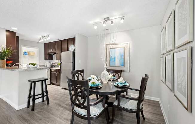 A dining room with a table set for four.