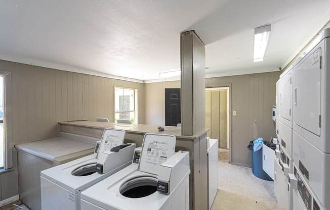 A laundry room with washers and dryers.