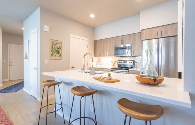 a kitchen with an island and stools