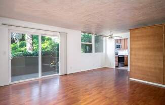 A room with wooden floors and a ceiling fan.