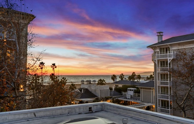 the view of the ocean from the backyard of a house with a pool and a