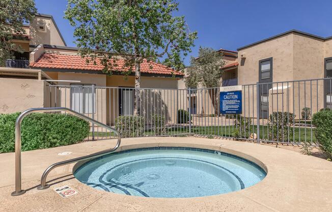 a house with a pool in front of a brick building