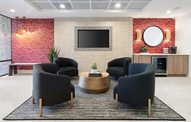 Clubroom with chairs, table and a television at Vera Cortez Hill, San Diego