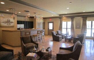 Clubhouse with brown chairs and a glass table at Forest Hill, 36618