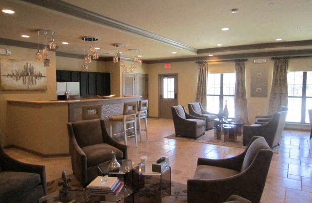 Clubhouse with brown chairs and a glass table at Forest Hill, 36618