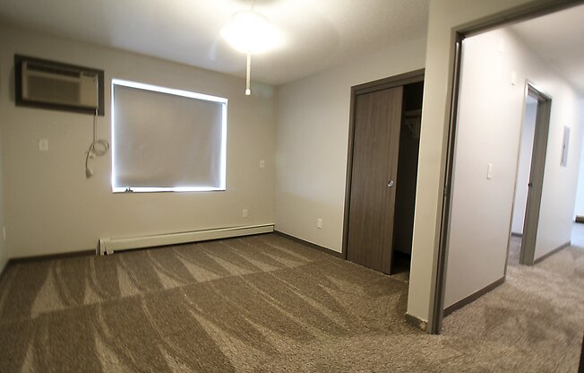 an empty room with a whiteboard on the wall
