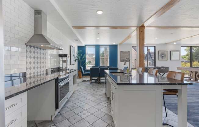 a kitchen with an island and a dining room with a table and chairs