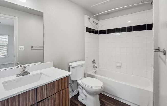 a bathroom with a toilet and a tub and a sink