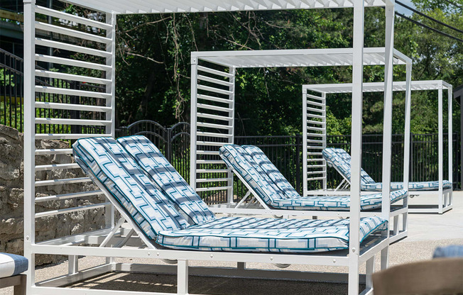 a group of lounge chairs on a patio at The Heights Apartments, Cincinnati