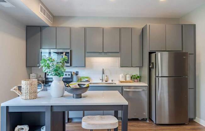 A modern kitchen with a table and chairs.