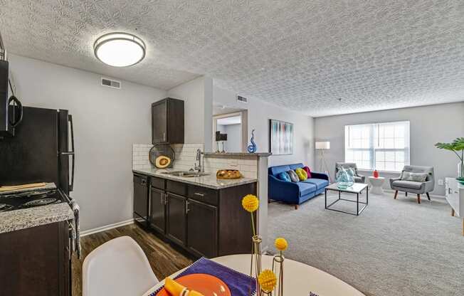 a living room with a kitchen and a dining room