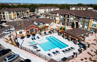 an aerial view of an apartment complex with a swimming pool