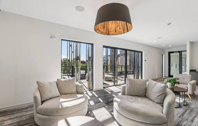 Modern living room with a large window and a view of the city at Park77 Apartments, Cambridge, MA
