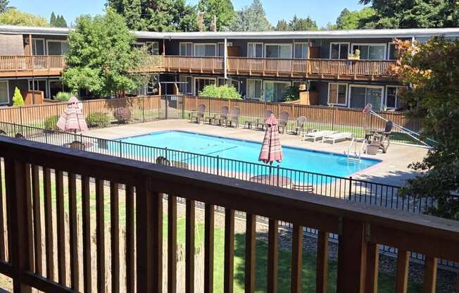 a view of the pool from the balcony of a resort