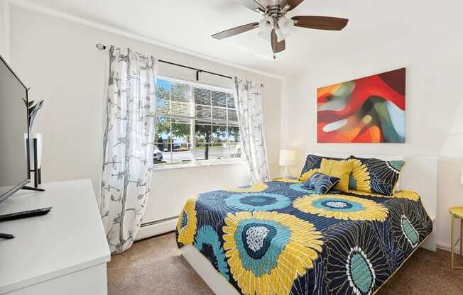 apartment bedroom with a ceiling fan