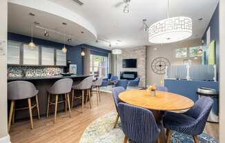 a dining room and kitchen with a table and chairs