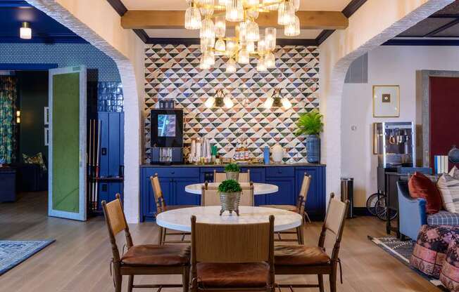 A dining room with a table set for four.