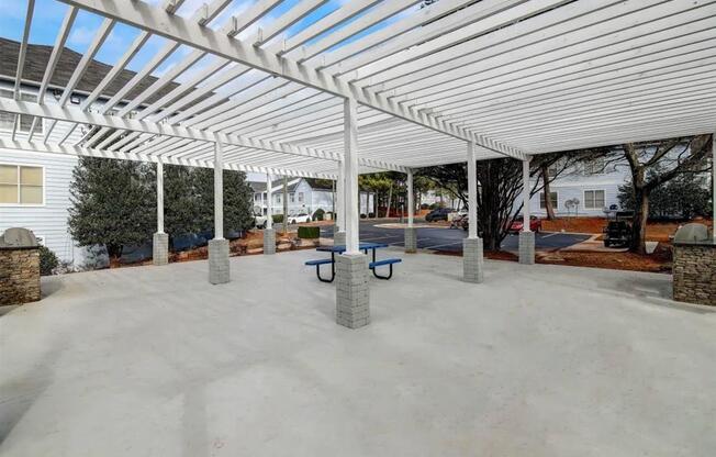 a covered patio with benches under a white canopy at The Sapphire, Decatur, Georgia