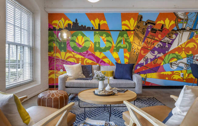 a living room with a colorful mural on the wall at Highland Mill Lofts, North Carolina, 28205