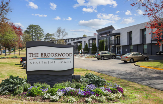 the brookwood apartment homes sign in front of a parking lot