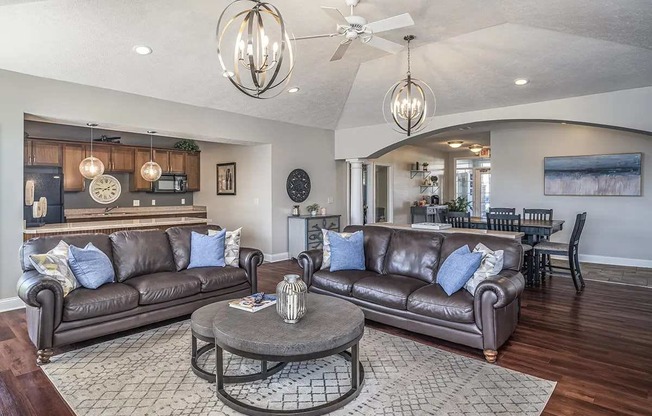 a living room filled with furniture and a ceiling fan