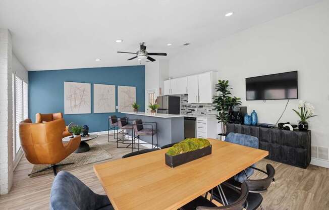 A modern kitchen with a dining table and chairs.