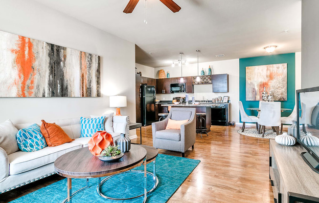 a living room with a white couch and a blue rug