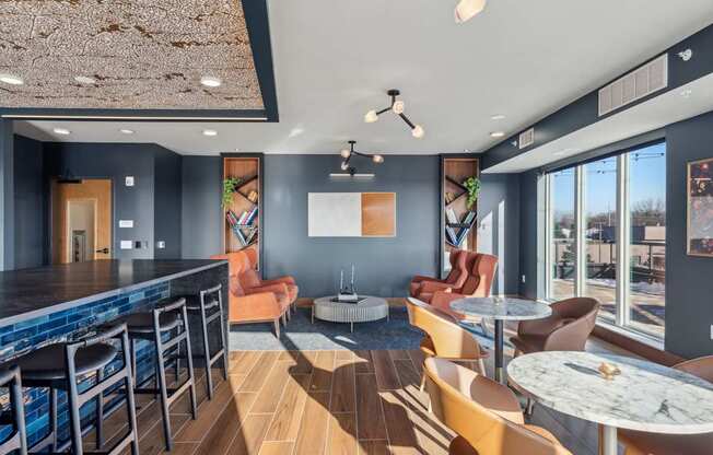 A modern bar area with a pool table and comfortable seating.