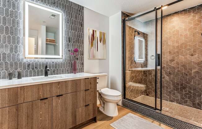 a bathroom with a shower toilet and sink and a mirror