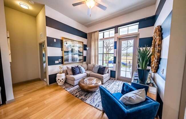 a living room with blue and white walls and a sliding glass door