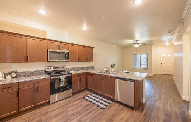 A kitchen with wooden cabinets and stainless steel appliances.