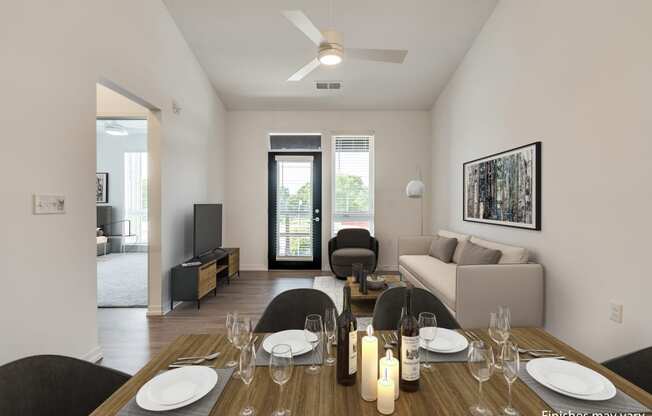 a dining area with a wooden table and chairs and a living room with a couch and a