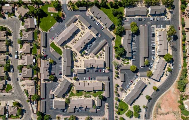 an aerial view of a city with houses and cars