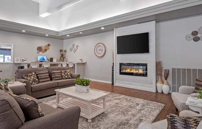 a living room with couches a coffee table and a fireplace