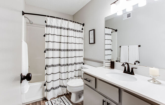 a bathroom with a sink toilet and shower at The Laurel, Union City