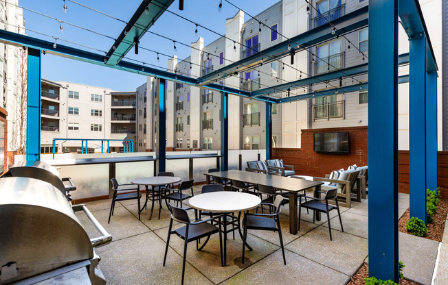 a patio with tables and chairs outside of a building