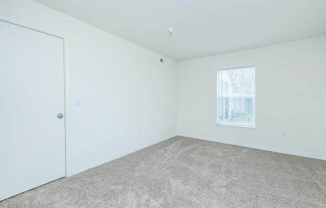 a bedroom with a bed in a room