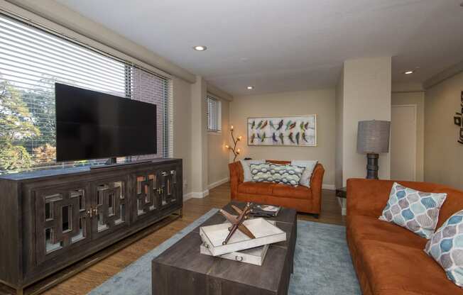 a living room filled with furniture and a flat screen tv