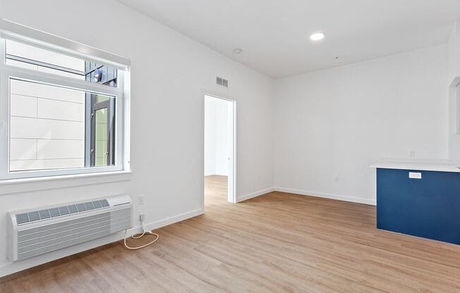 a living room with wood floors and a window