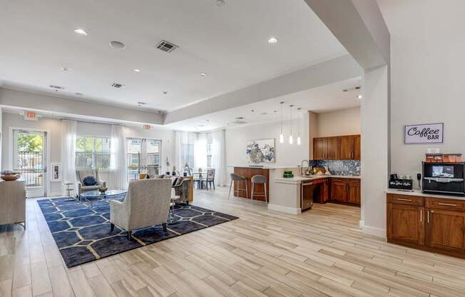 A spacious living room with a kitchen area in the background.