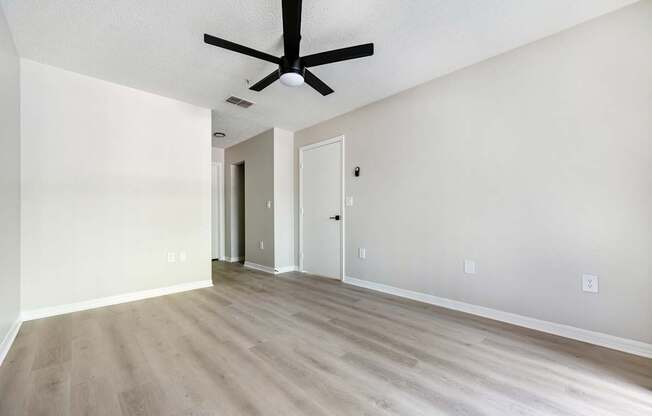 A room with a ceiling fan and light fixture.