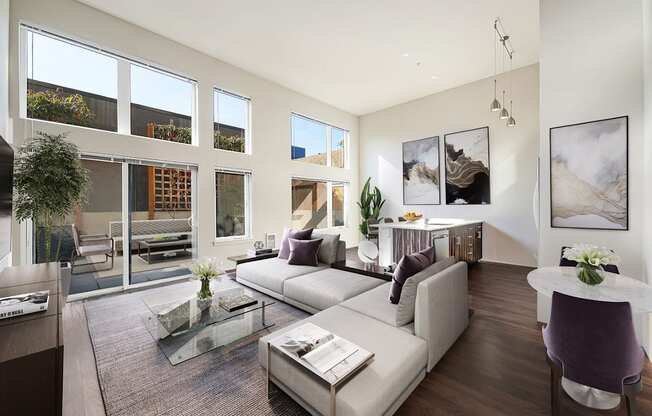 The Hayes on Stone Way Apartments  living room with a couch and a coffee table and large windows at The Hayes on Stone Way, Seattle, WA