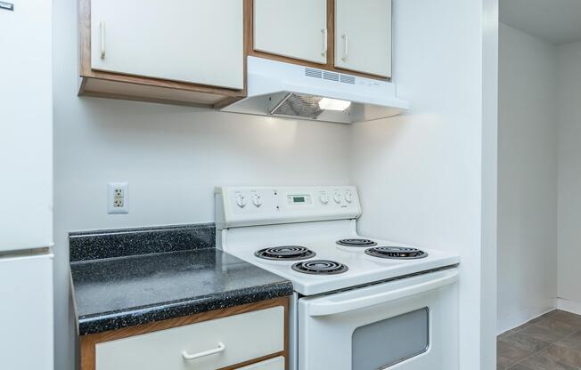 a stove top oven sitting inside of a kitchen
