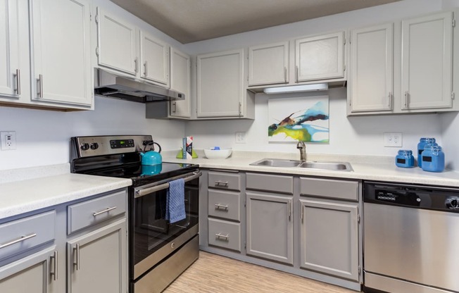 a kitchen with white cabinets and a black stove top oven