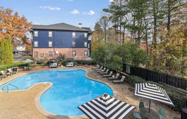A large blue building with a pool in front.