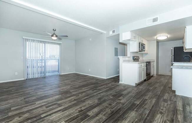 A room with wooden flooring and a ceiling fan.