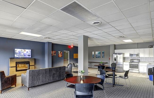 A modern living room with a grey couch, a fireplace, and a television.