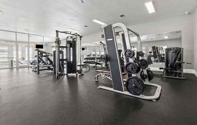 A gym with a variety of equipment including a leg press machine.