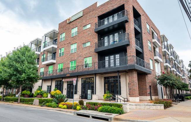 a red brick apartment building on a city street